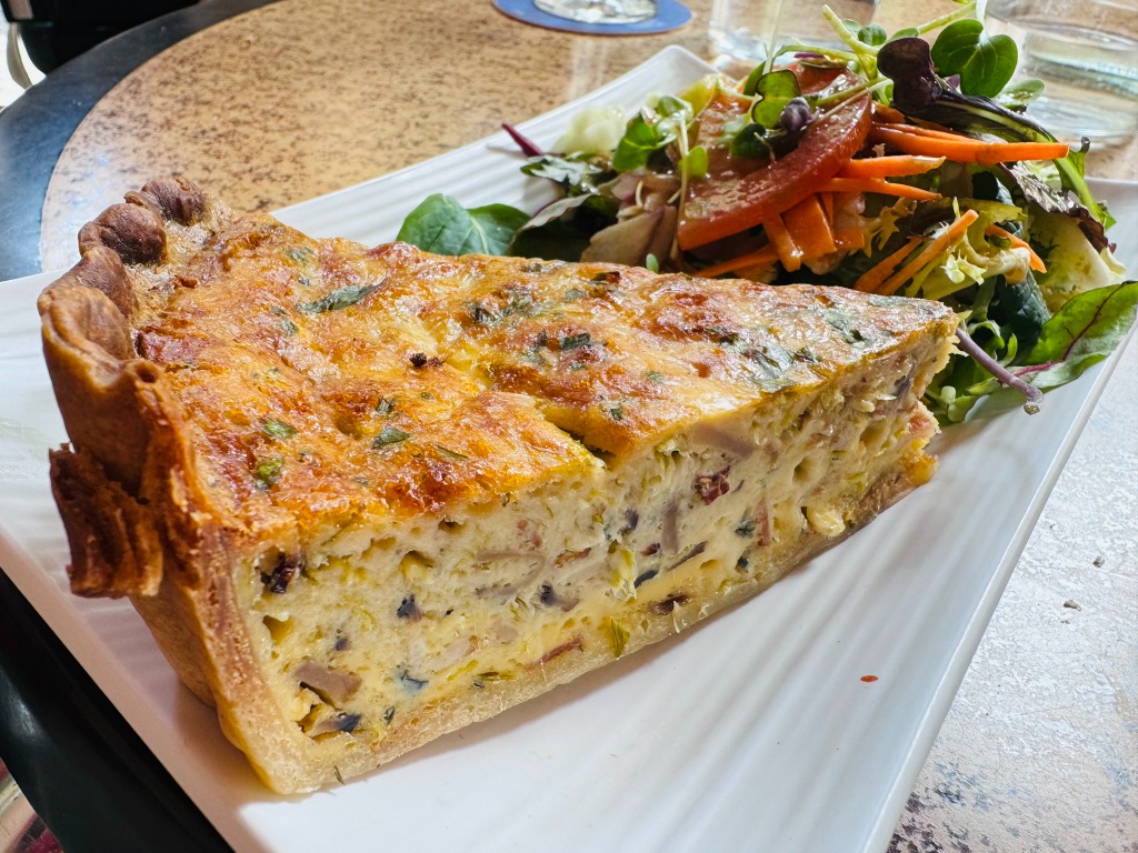 Carta de Bares en Barcelona, Kasparo, Quiche de champiñón, bacon y queso azul servida con ensalada