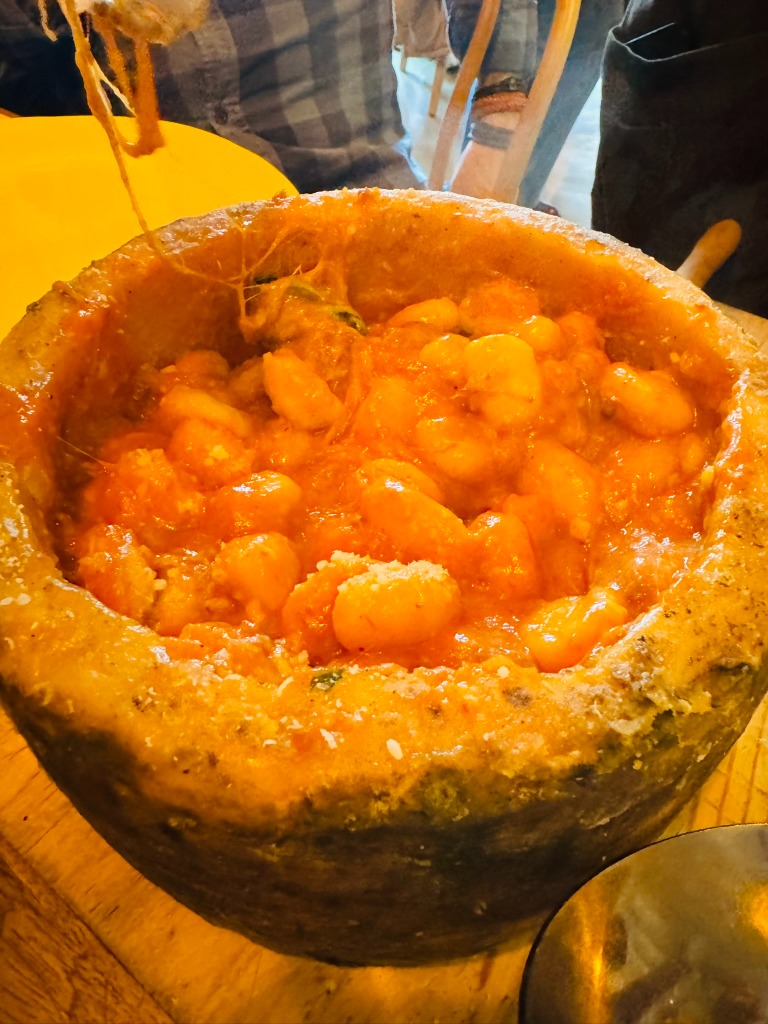 Menu of Restaurants in Barcelona, concepto nonna, Gnocchi con ragú napoletano servido en rueda de queso pecorino